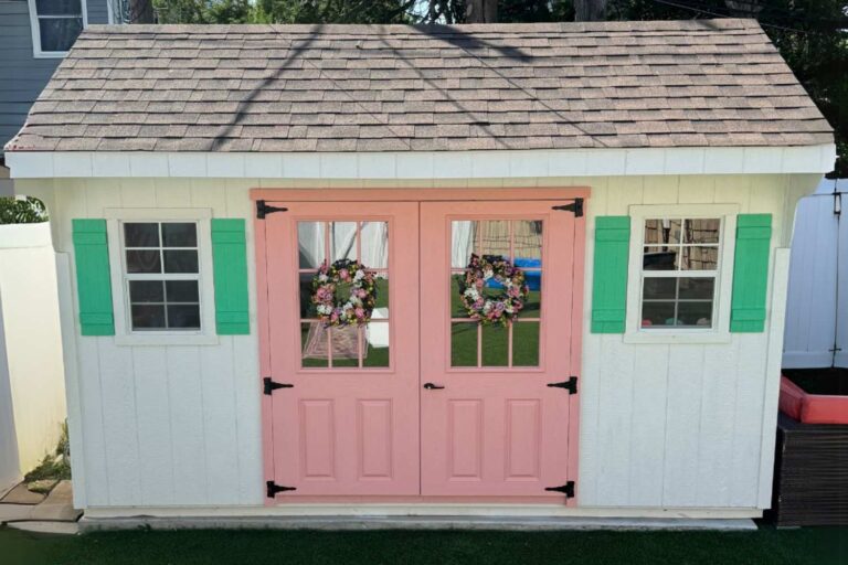 10x14 Art Studio Saltbox Shed in NY with white siding, green shutters, and pink doors