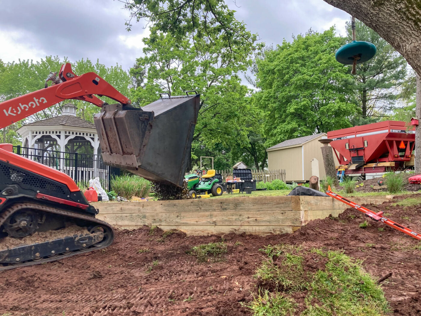 pouring the stone in the process of installing a gravel shed pad