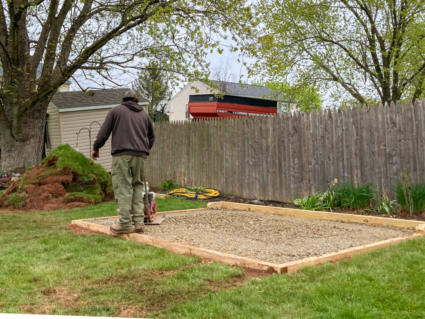 using a plate compactor in the process of installing a gravel shed pad