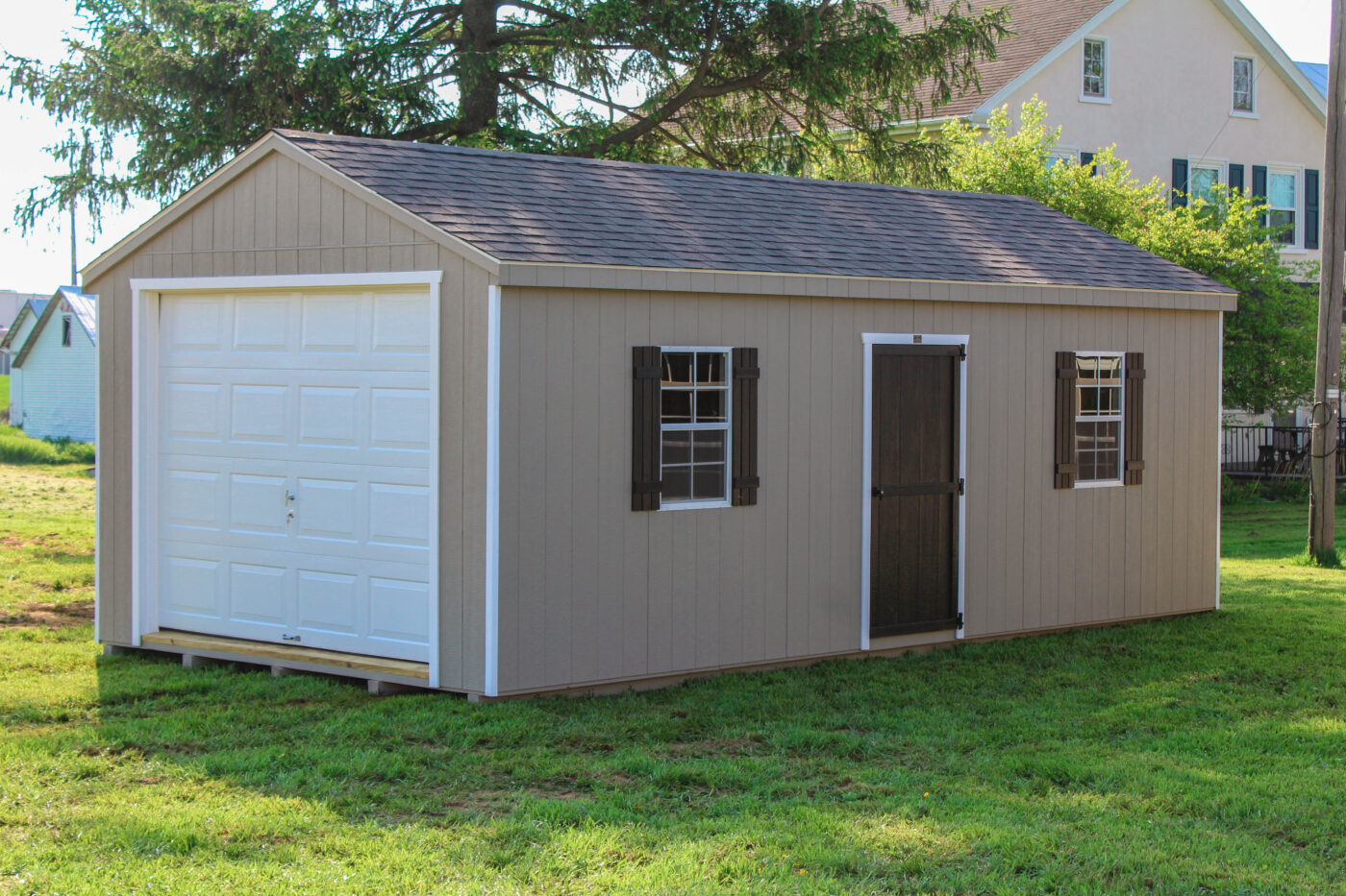 A large shed kit configured as a single-car garage kit