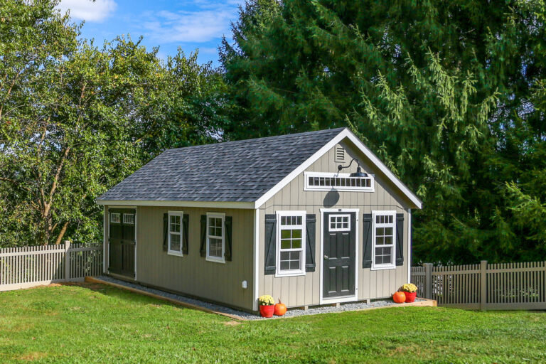 Classic gray man cave shed with white trim, double doors, and a side window.